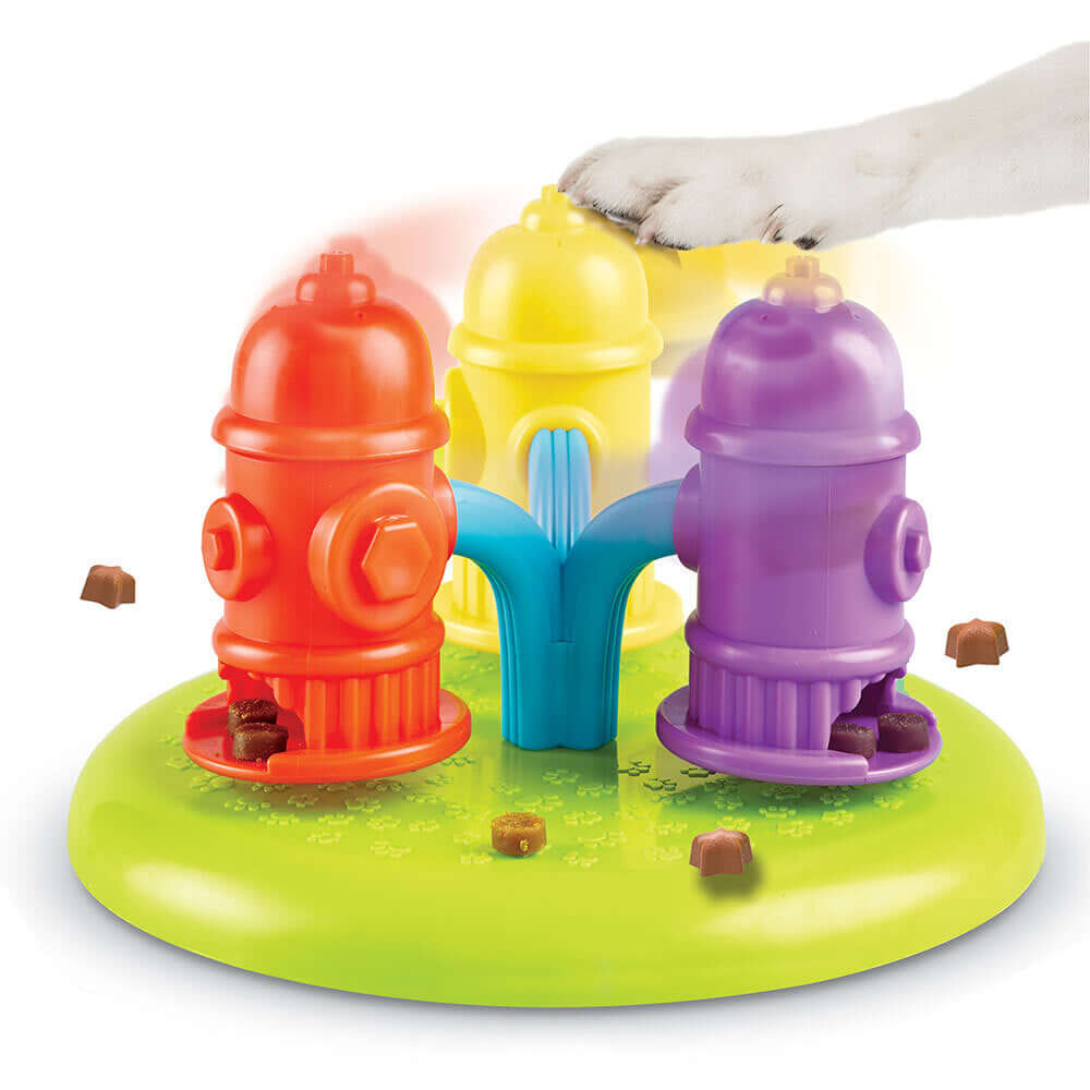 Brightkins Spinning Hydrants Jutalomfalat Puzzle for dogs, featuring colorful spinning fire hydrants hiding treats, with a playful paw in action.